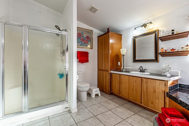 bathroom featuring tile patterned floors, toilet, vaulted ceiling, vanity, and walk in shower