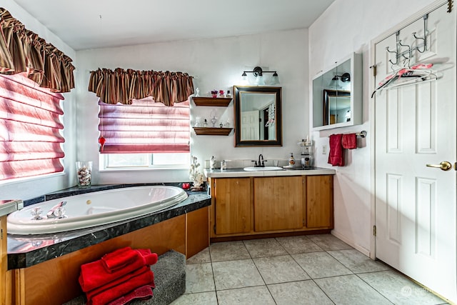 bathroom with vanity, a tub, and tile patterned floors