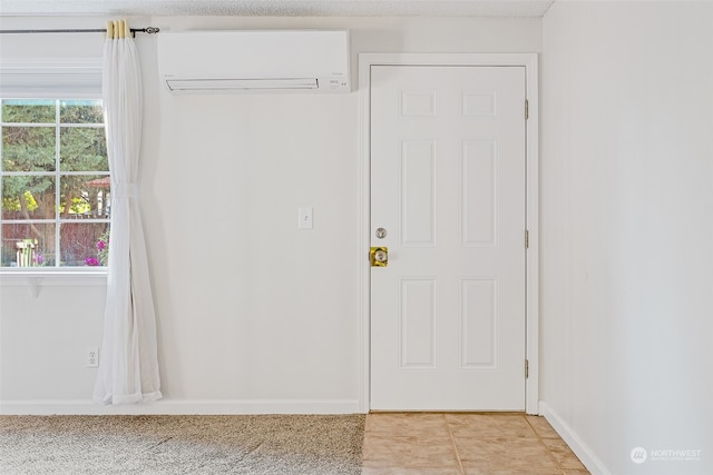 doorway with light carpet, an AC wall unit, and a textured ceiling