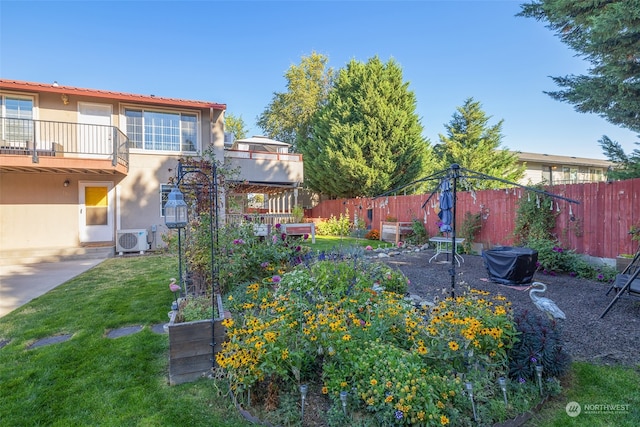 view of yard with a balcony, ac unit, and a patio