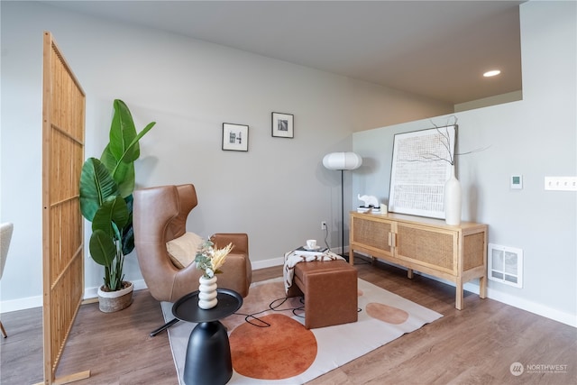 living area with hardwood / wood-style floors