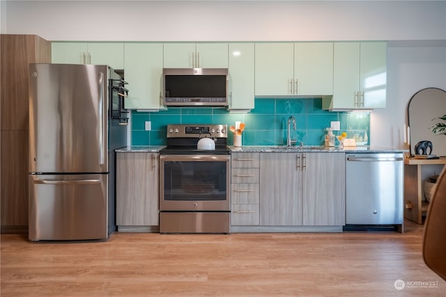 kitchen featuring light hardwood / wood-style floors, stainless steel appliances, and sink