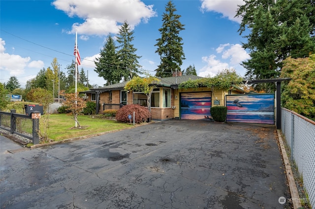 view of front of home with a front yard and a garage