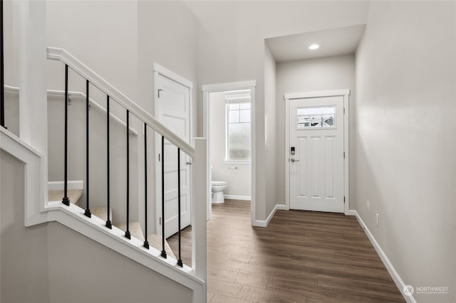 entrance foyer featuring stairs, baseboards, recessed lighting, and dark wood-style flooring