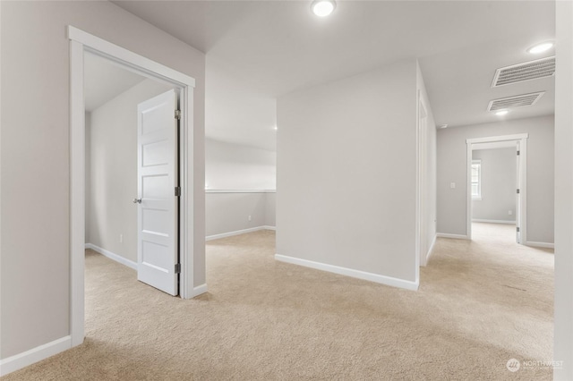 corridor featuring baseboards, recessed lighting, visible vents, and carpet