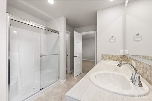 full bathroom with a sink, decorative backsplash, and a stall shower