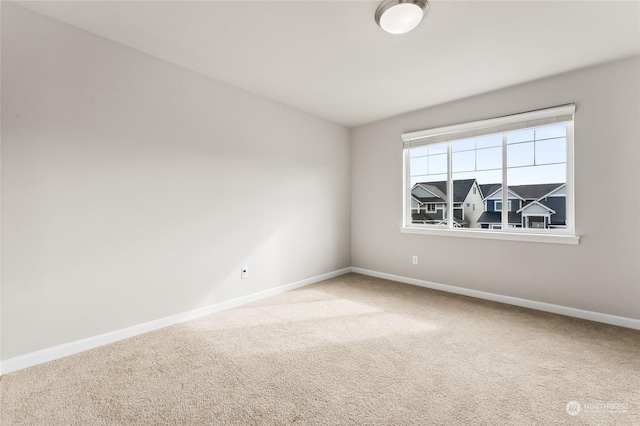 empty room with carpet flooring and baseboards