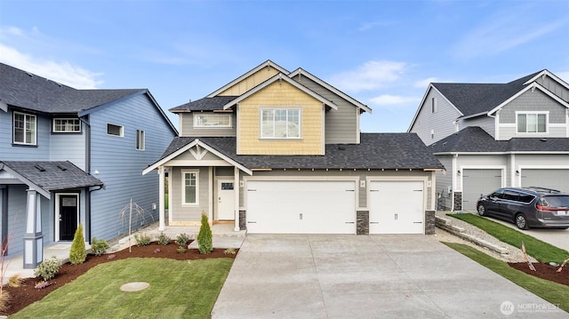 craftsman inspired home with concrete driveway, a shingled roof, a garage, and a front lawn