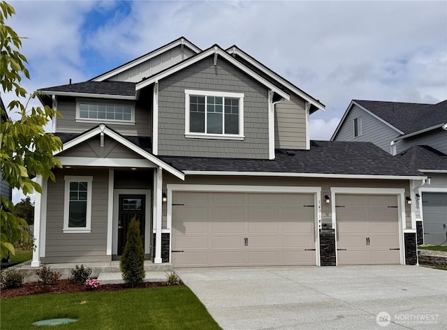 14714 88th Way SE Unit 3, Yelm, WA 98597 - craftsman-style home featuring driveway, an attached garage, roof with shingles, and stone siding