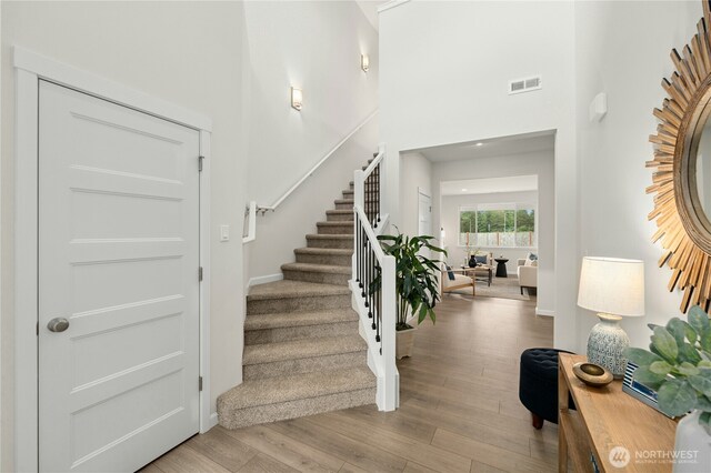 14714 88th Way SE Unit 3, Yelm, WA 98597 - entrance foyer featuring stairs, wood finished floors, and a towering ceiling