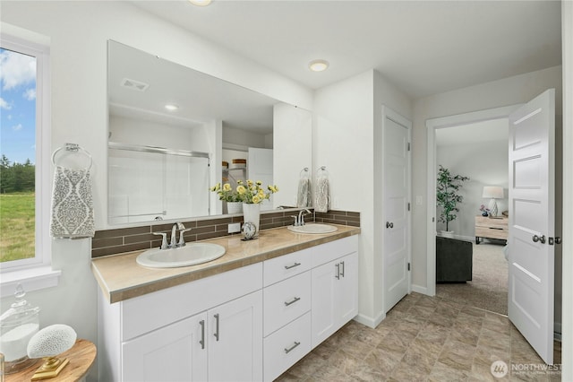14714 88th Way SE Unit 3, Yelm, WA 98597 - bathroom featuring double vanity, backsplash, healthy amount of natural light, and recessed lighting