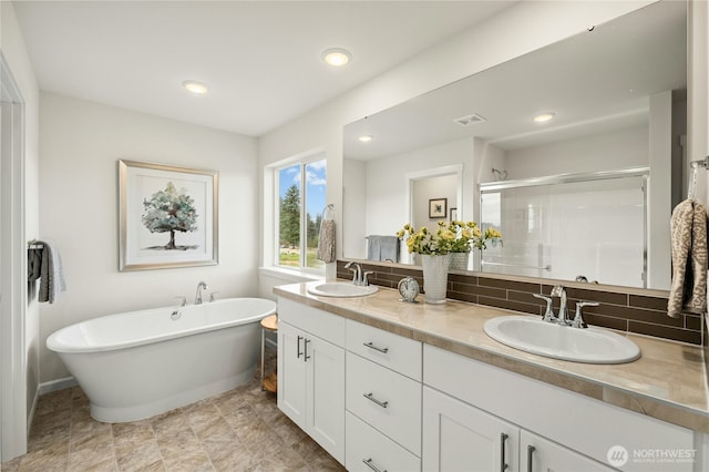 14714 88th Way SE Unit 3, Yelm, WA 98597 - full bathroom featuring double vanity, a shower stall, a soaking tub, backsplash, and recessed lighting