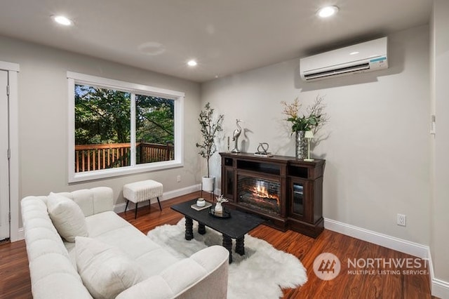 living room with an AC wall unit and dark hardwood / wood-style floors