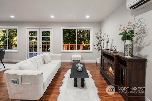 living room with french doors, dark hardwood / wood-style flooring, and a wall mounted air conditioner