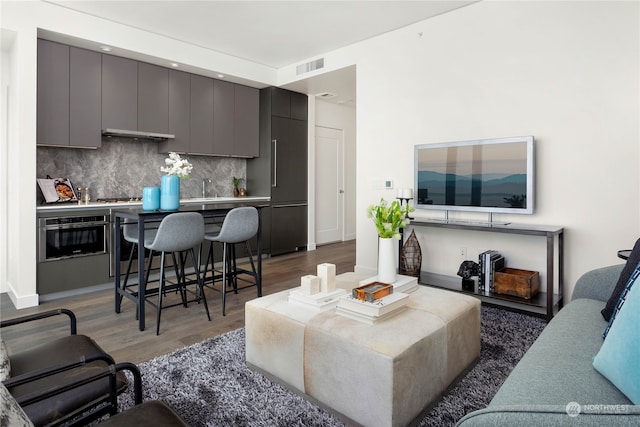 living room with sink and dark hardwood / wood-style floors