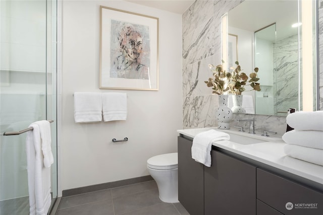 bathroom featuring vanity, toilet, tile patterned floors, and walk in shower