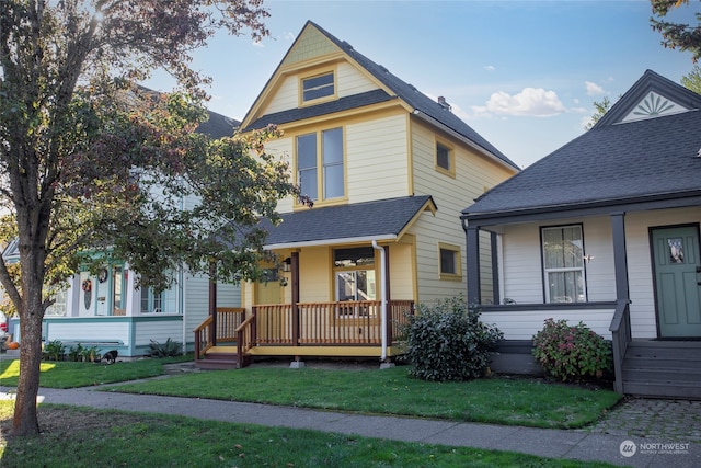 view of front of property featuring covered porch and a front yard