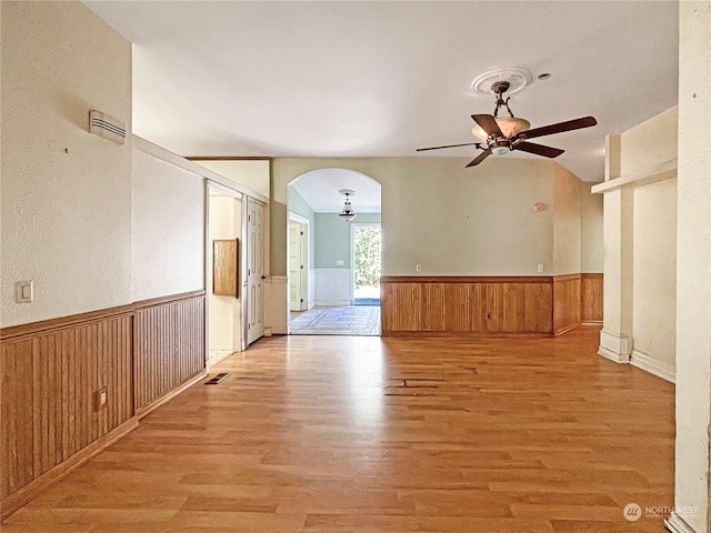 spare room featuring lofted ceiling, light hardwood / wood-style floors, and ceiling fan