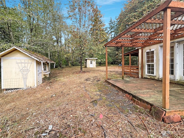 view of yard featuring a storage unit and a deck