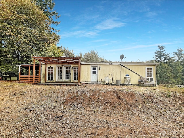 rear view of house featuring french doors