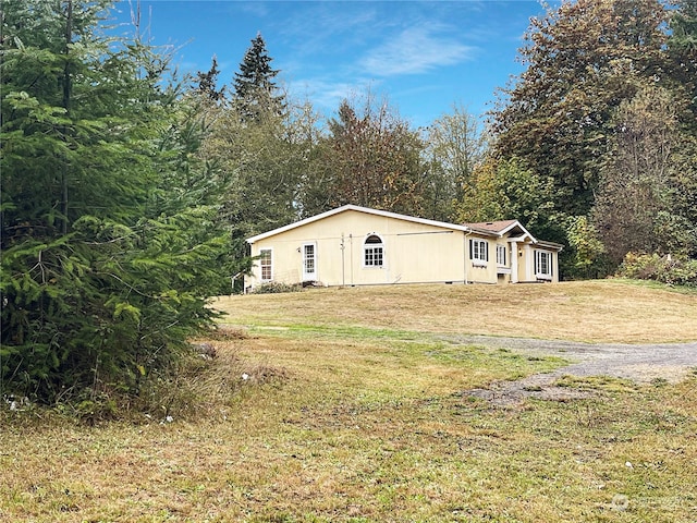 view of side of home with a yard