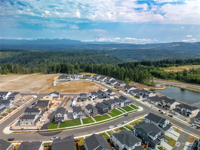 drone / aerial view with a water and mountain view