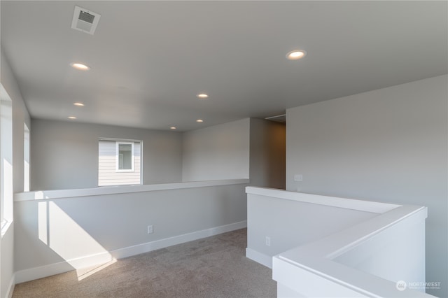 unfurnished room featuring light colored carpet