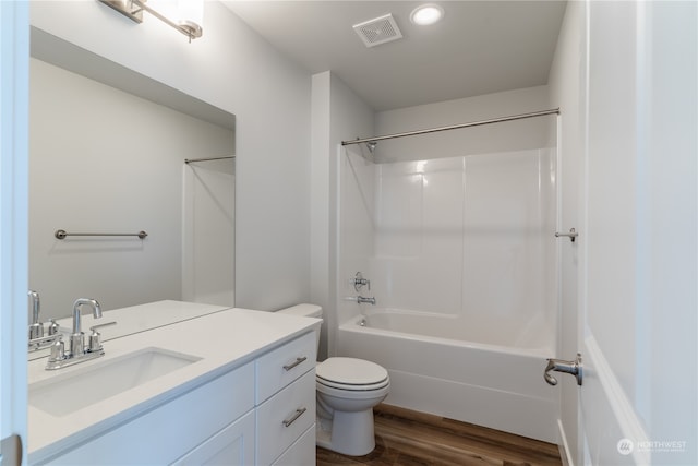 full bathroom featuring vanity, bathing tub / shower combination, hardwood / wood-style flooring, and toilet