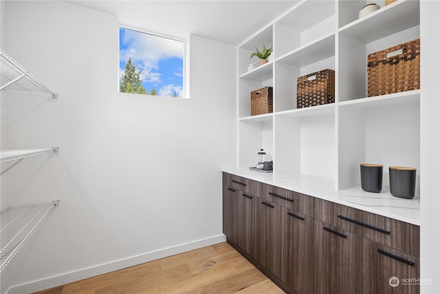 interior space with dark brown cabinets and light hardwood / wood-style floors