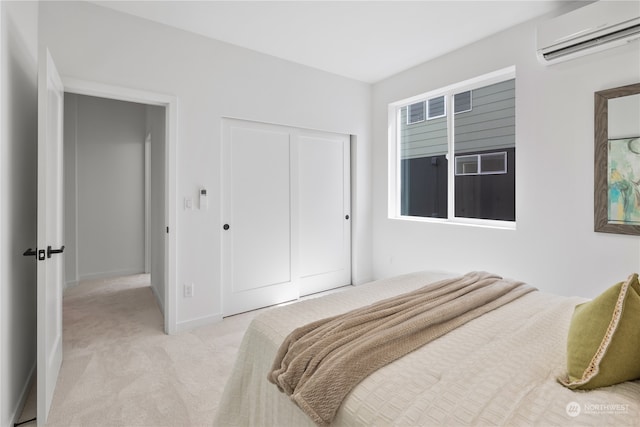 bedroom with a wall unit AC, light colored carpet, and a closet