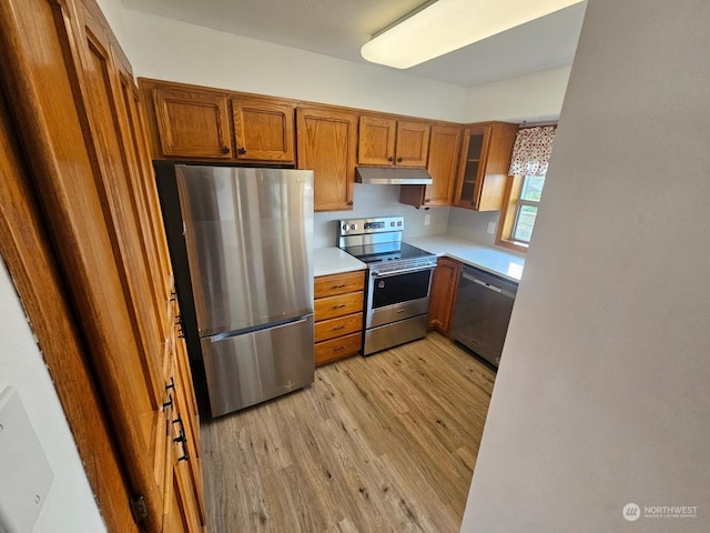 kitchen featuring stainless steel appliances and light hardwood / wood-style floors