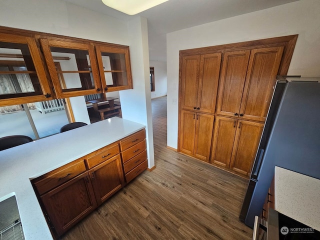 kitchen with wood-type flooring and stainless steel refrigerator