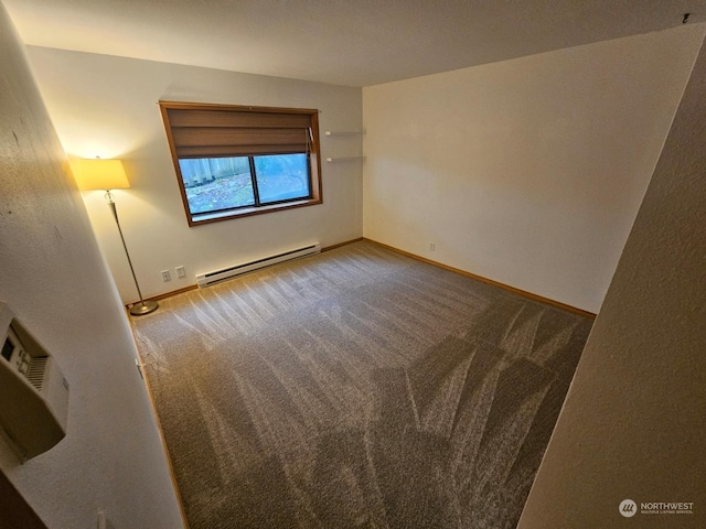 carpeted spare room with a baseboard radiator