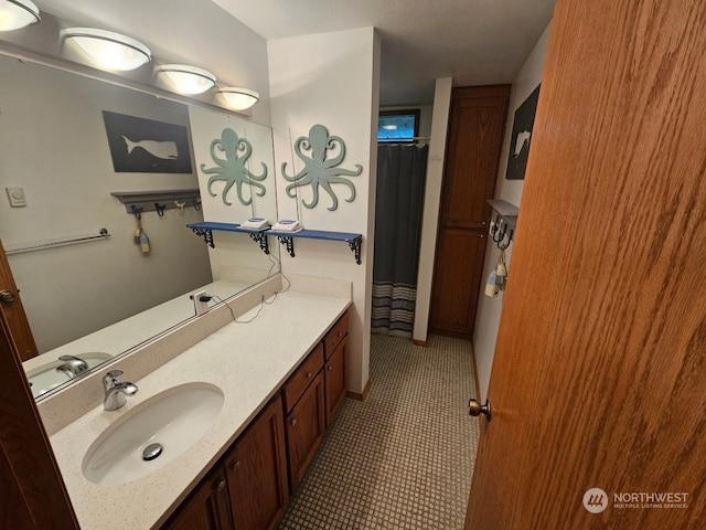 bathroom with tile patterned flooring, vanity, and curtained shower