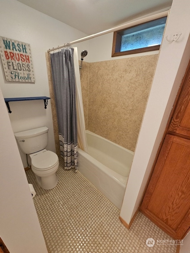 bathroom featuring tile patterned flooring, shower / bath combination with curtain, and toilet