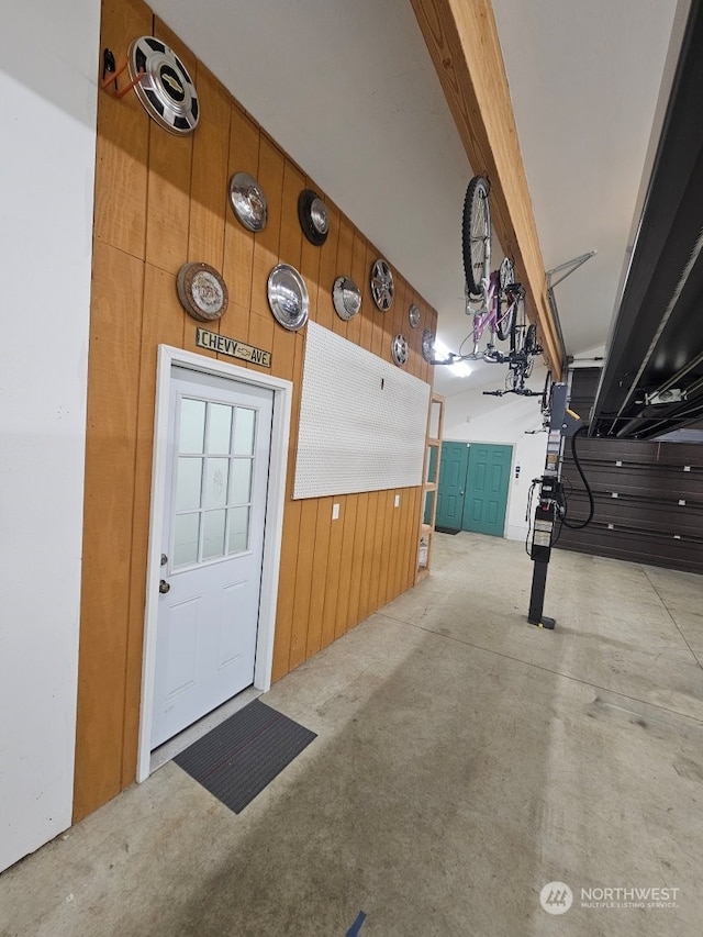 garage featuring wood walls