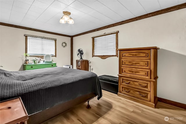 bedroom featuring light hardwood / wood-style flooring and crown molding