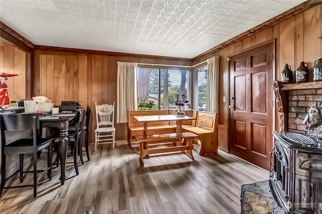 interior space with wood walls, a wood stove, and dark hardwood / wood-style floors