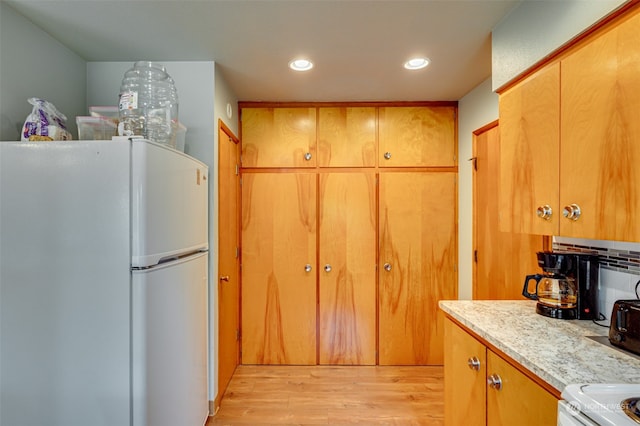 kitchen featuring light wood-type flooring and white refrigerator