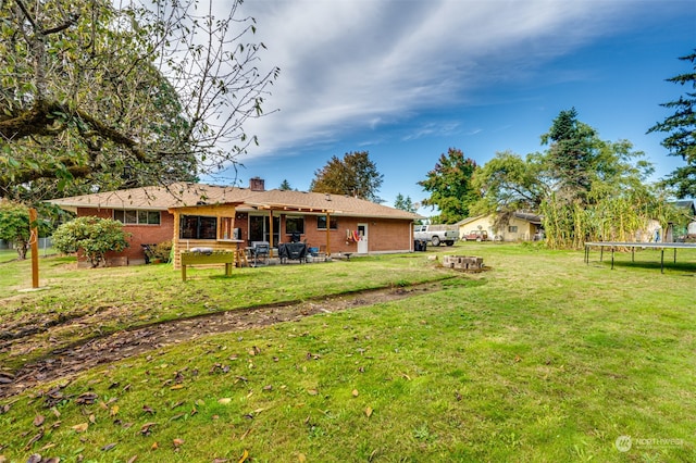 view of yard featuring a trampoline and a patio area