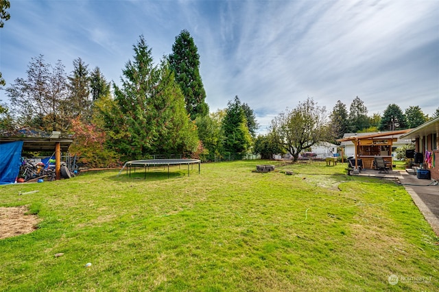 view of yard with a patio and a trampoline