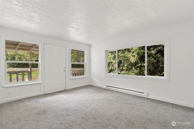 carpeted empty room with a baseboard radiator and a textured ceiling