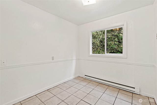 tiled spare room featuring a baseboard radiator