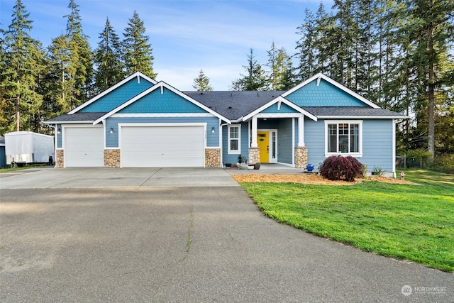 craftsman inspired home featuring a front lawn and a garage