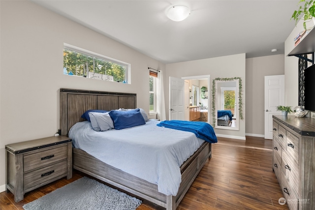 bedroom with dark hardwood / wood-style floors