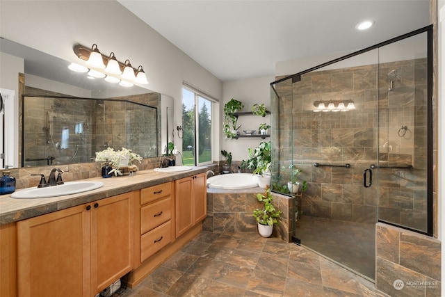 bathroom with vanity and shower with separate bathtub