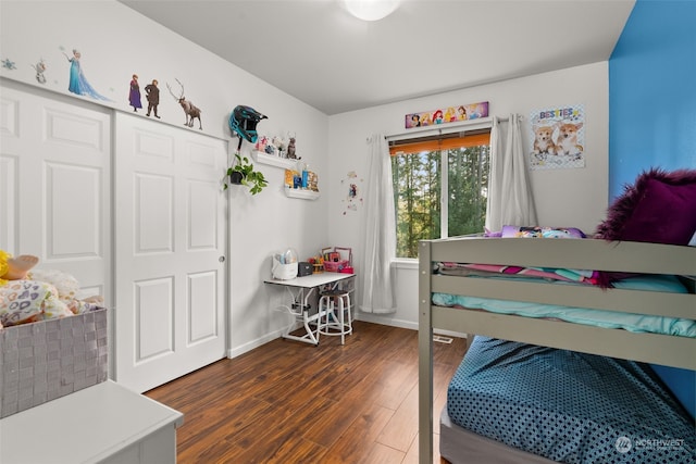 bedroom featuring a closet and dark hardwood / wood-style flooring