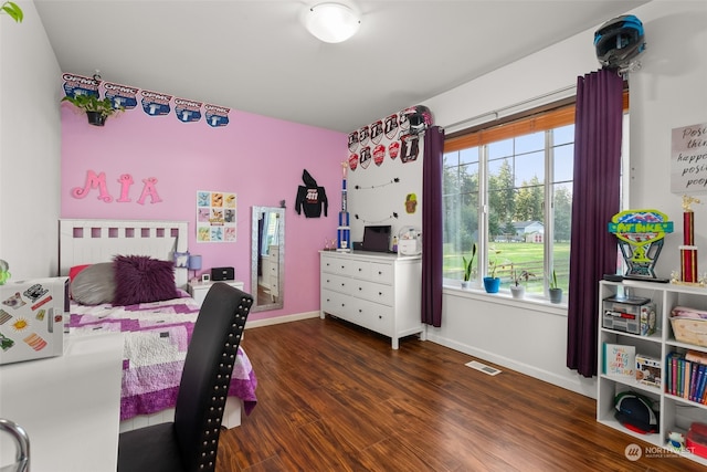 bedroom with dark wood-type flooring