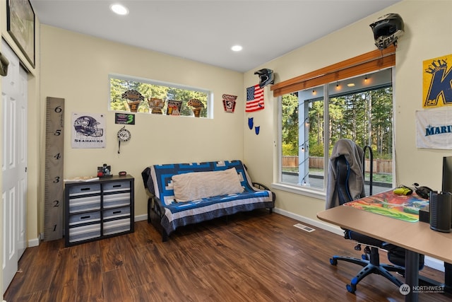 office with dark wood-type flooring and a healthy amount of sunlight