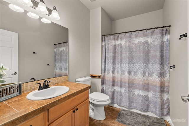 bathroom featuring toilet, tile patterned flooring, backsplash, vanity, and walk in shower